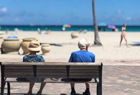 Retirement - Man and Woman Sitting on Brown Wooden Bench