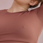 Workout Routines - A Woman in Brown Activewear Stretching