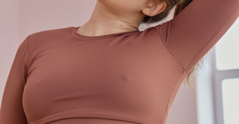 Workout Routines - A Woman in Brown Activewear Stretching