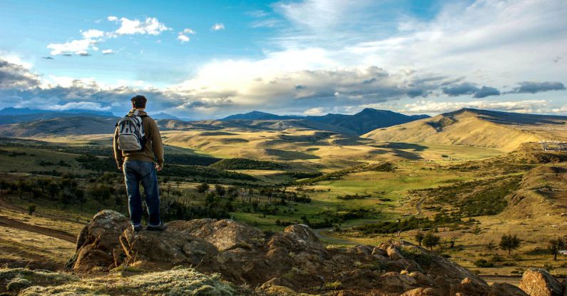 Solo Trekking - Man Walking Across Rio Turbio in Patagonia