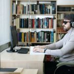 Learning Disabilities - Man Using the Braille in Front of a Computer