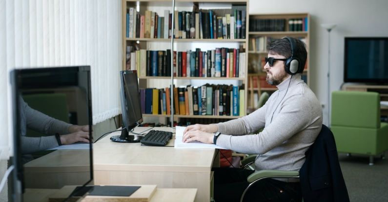 Learning Disabilities - Man Using the Braille in Front of a Computer