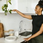Kitchen Organization - A Smiling Young Woman Organizing her Kitchen