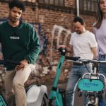 Rented Spaces - Friends on Rented Bikes on a Street