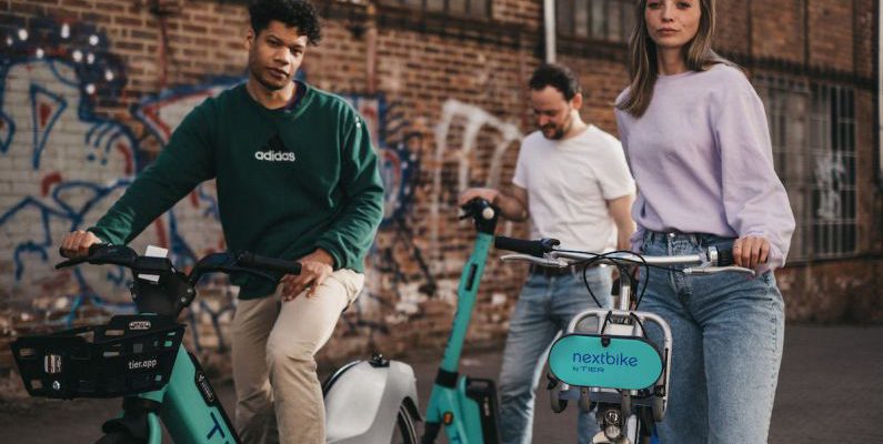 Rented Spaces - Friends on Rented Bikes on a Street