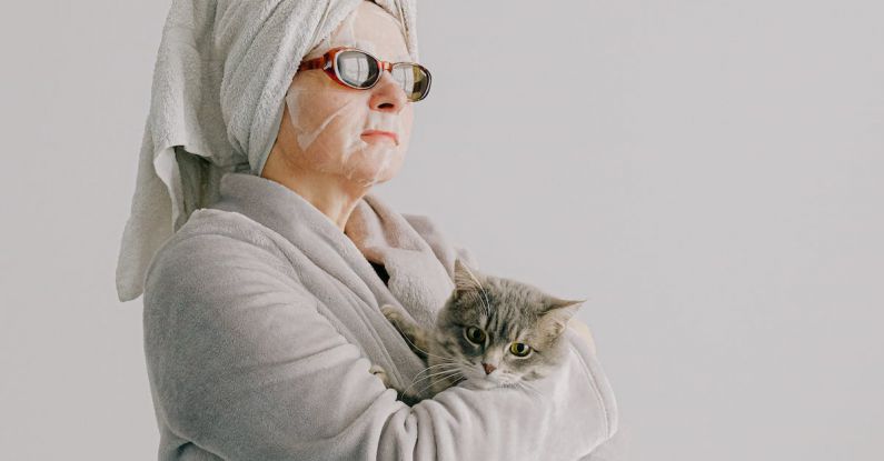 Pet-Safe Holiday - Woman after bath standing with cat in arms