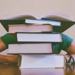 Student Loans - Person Behind Books