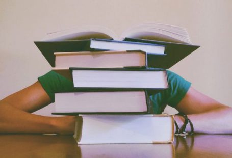 Student Loans - Person Behind Books