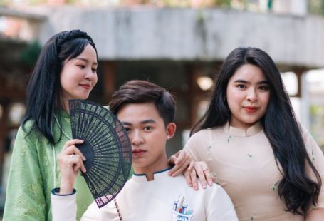 Eco-Friendly Party - Three asian people posing for a photo with a fan