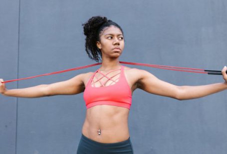 Bodyweight Exercises - Woman in Active Wear Stretching a Rope
