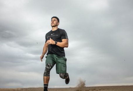 Workout - Man Running on Sand Field
