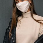 Face Masks - A Woman Wearing a Black Leather Jacket and a Face Mask