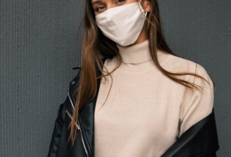 Face Masks - A Woman Wearing a Black Leather Jacket and a Face Mask